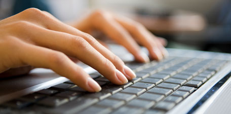 Image of hands typing on keyboard