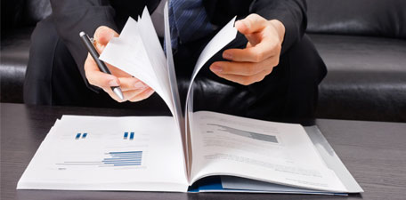 Photo of person flipping through report